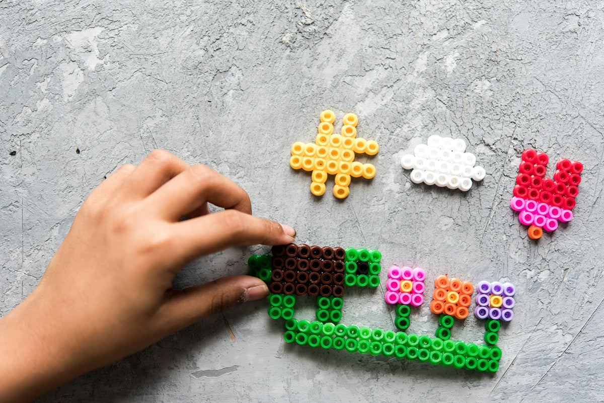 Kids creating colorful craft with beads, hands-on DIY activity kit