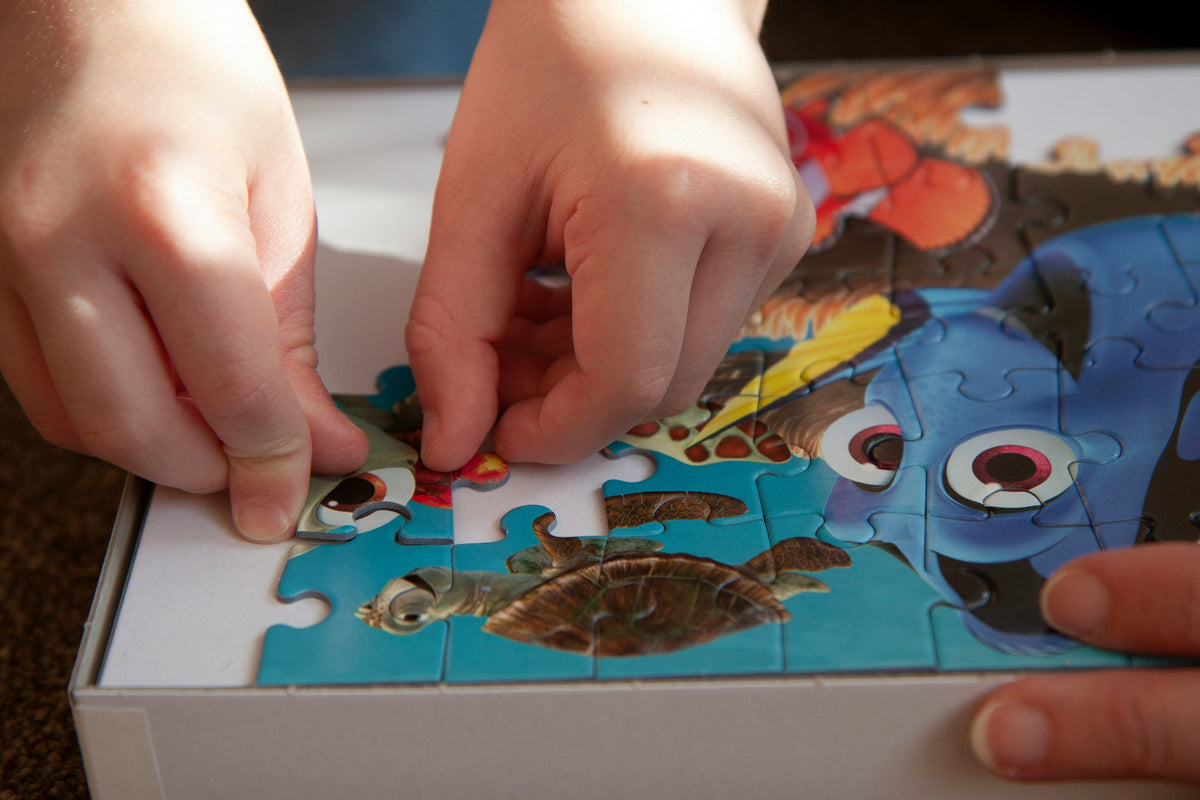 Child placing puzzle pieces, fine motor skill development activity