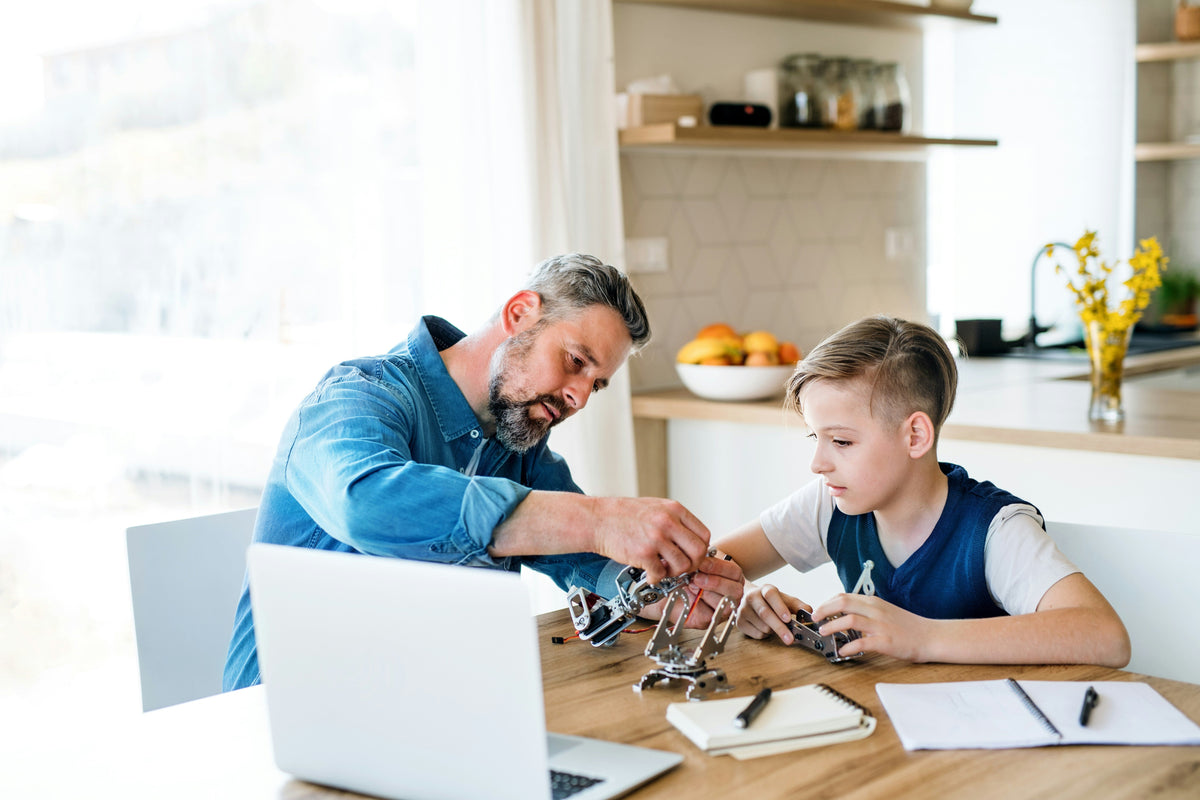 child using coding blocks with tablet for early stem learning
