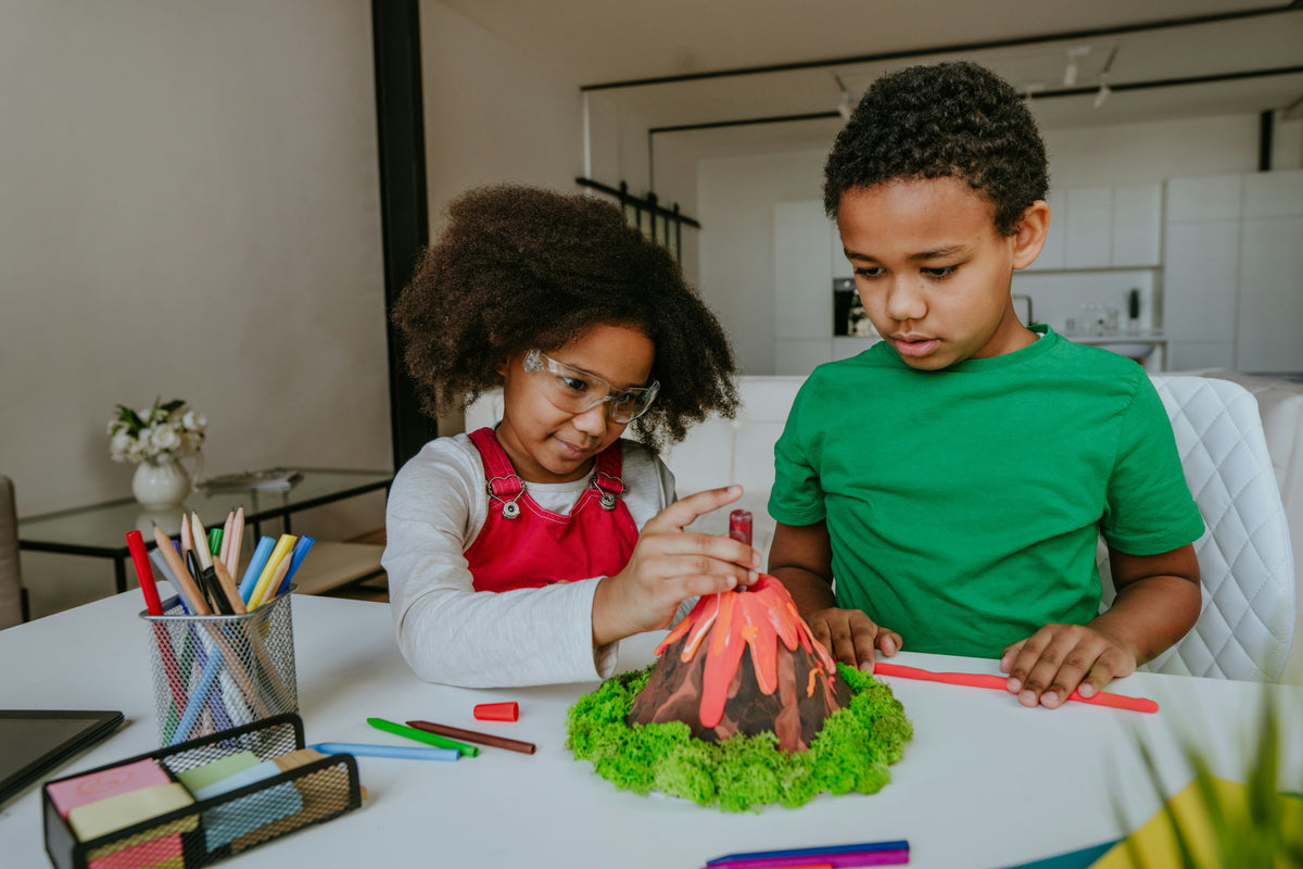 kids doing volcano science experiment at home, hands-on STEM learning activity
