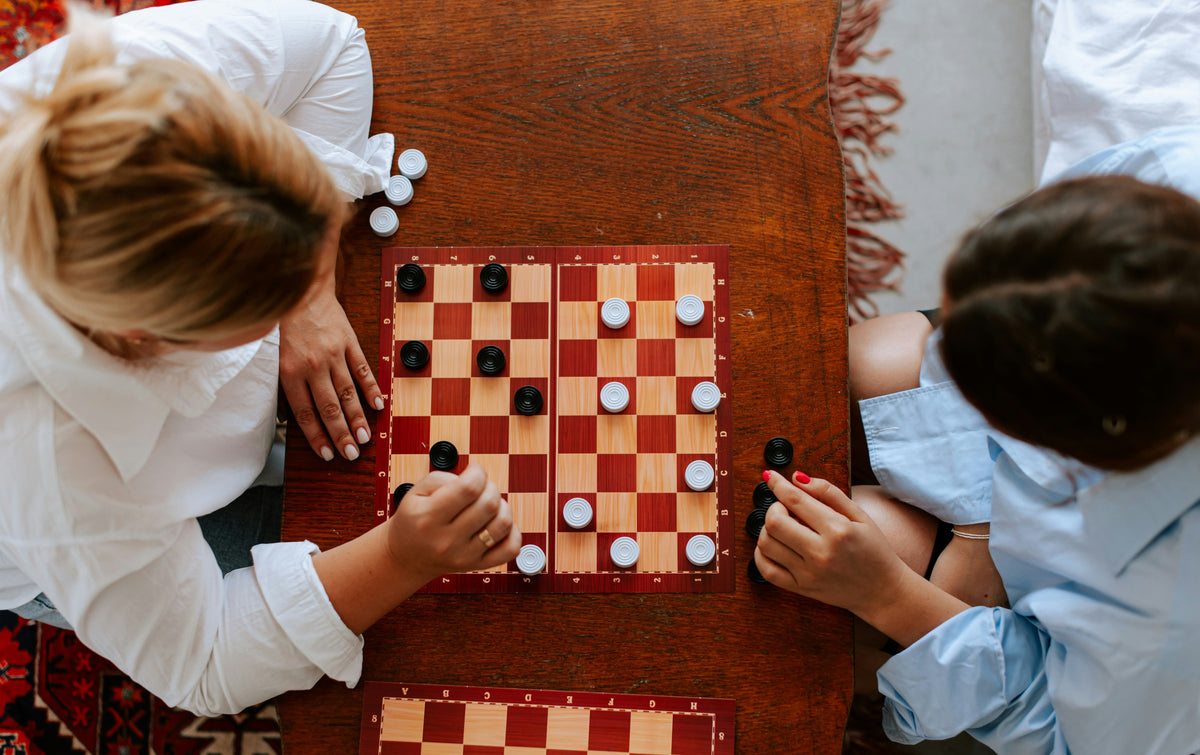 Parent and child playing board game together at home