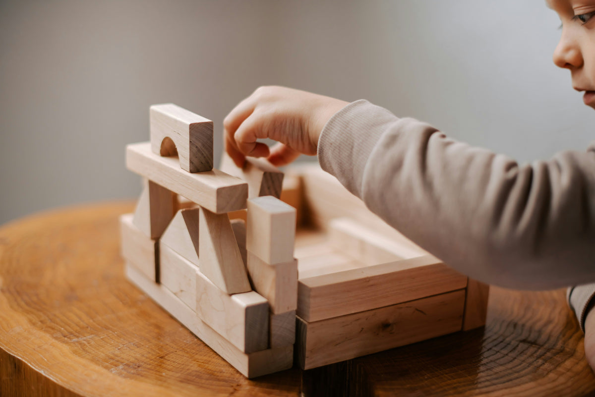 toddler building with wooden blocks montessori learning activity