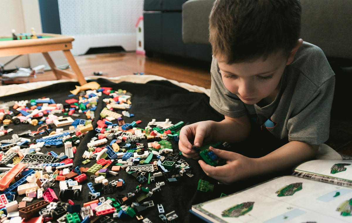 child building with blocks imaginative play at home