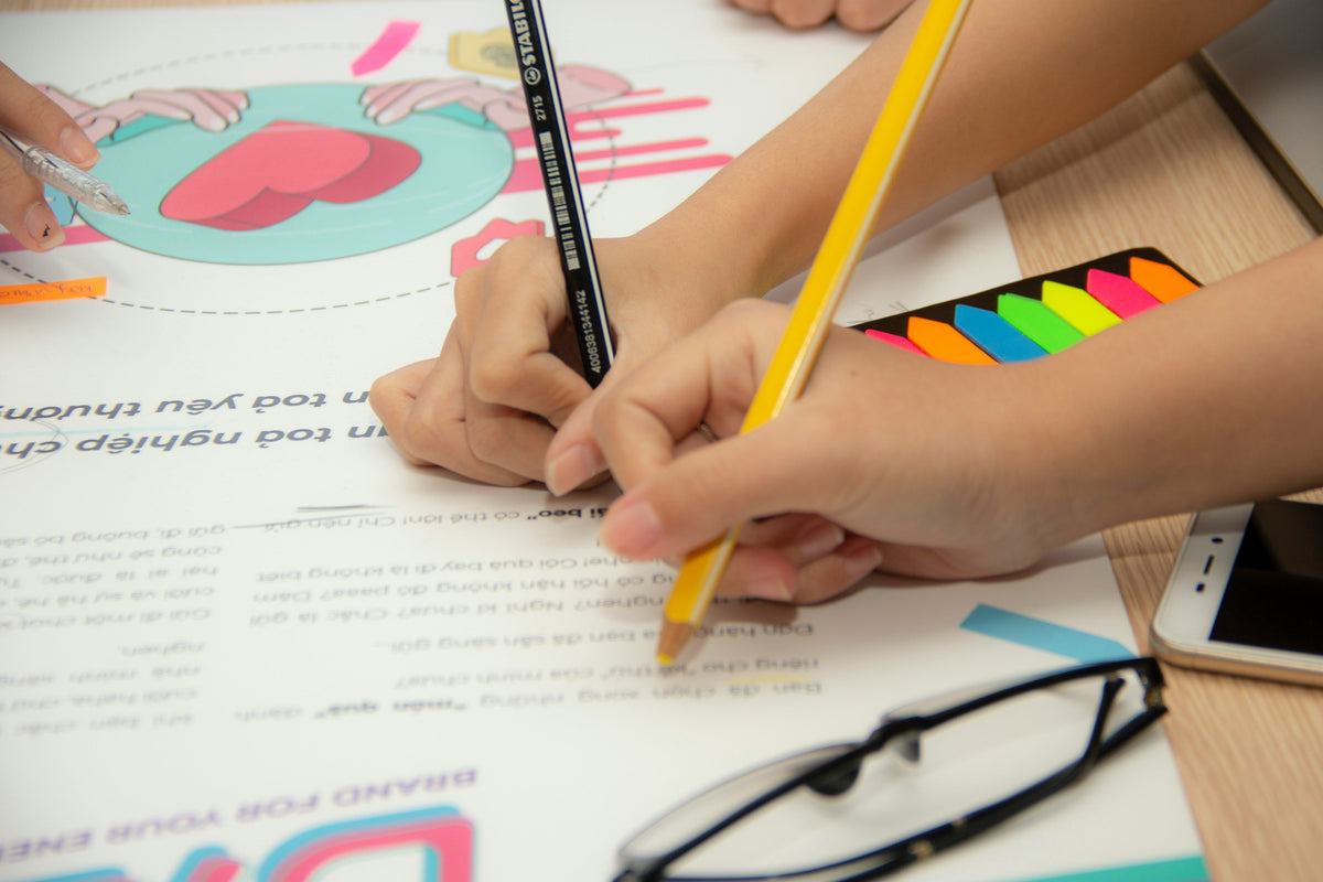 Child drawing with colored pencils to develop creativity and sensory skills